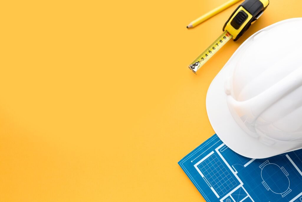 white-construction-hat-blue-print-with-copy-space
